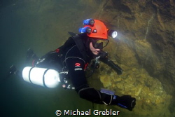 Sidemount diver near the surface after having completed a... by Michael Grebler 